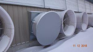 Giant fans with gray cover. Snow outside.