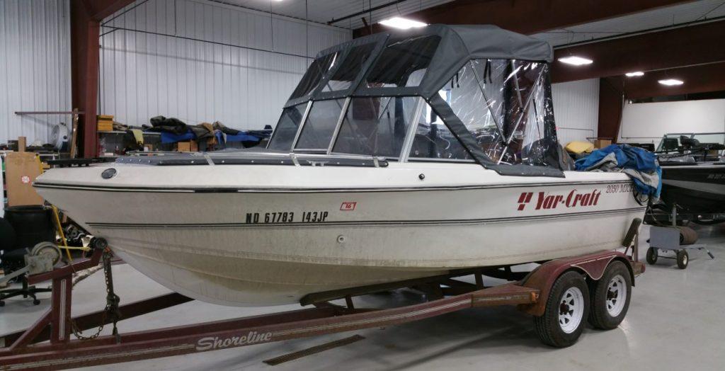 Yar Craft boat with black and clear canopy.