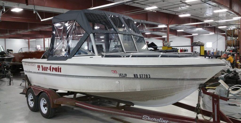 Yar Craft boat with black and clear canopy.