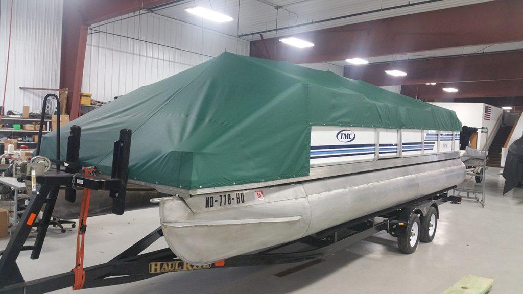 TMC Pontoon with green cover.