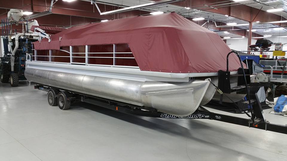 Pontoon with maroon cover.