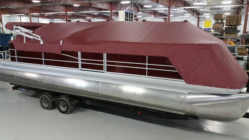 Pontoon with maroon cover.