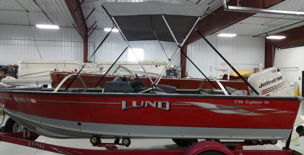 Red Lund boat with gray canopy