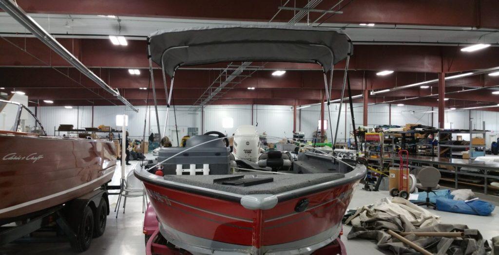 Red Lund boat with gray canopy