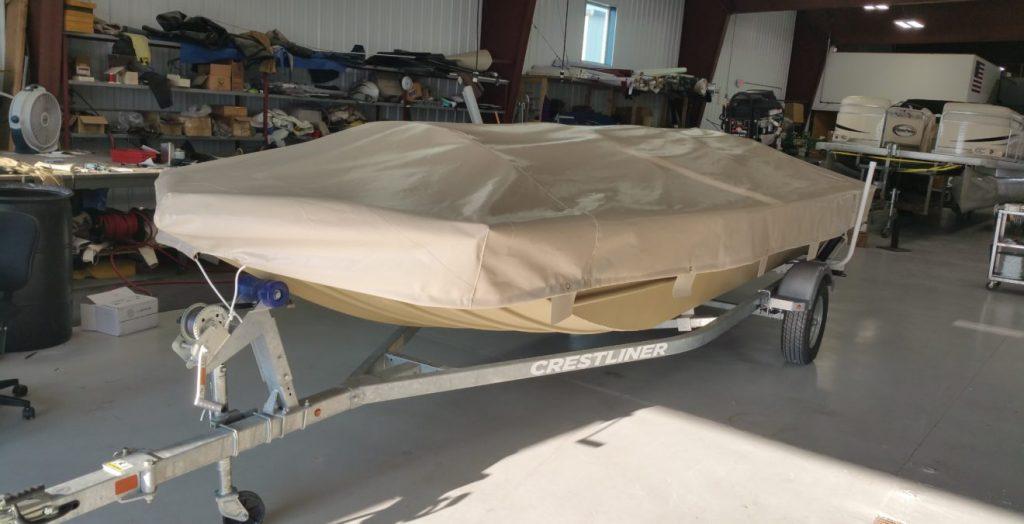 Crestliner boat with tan cover.