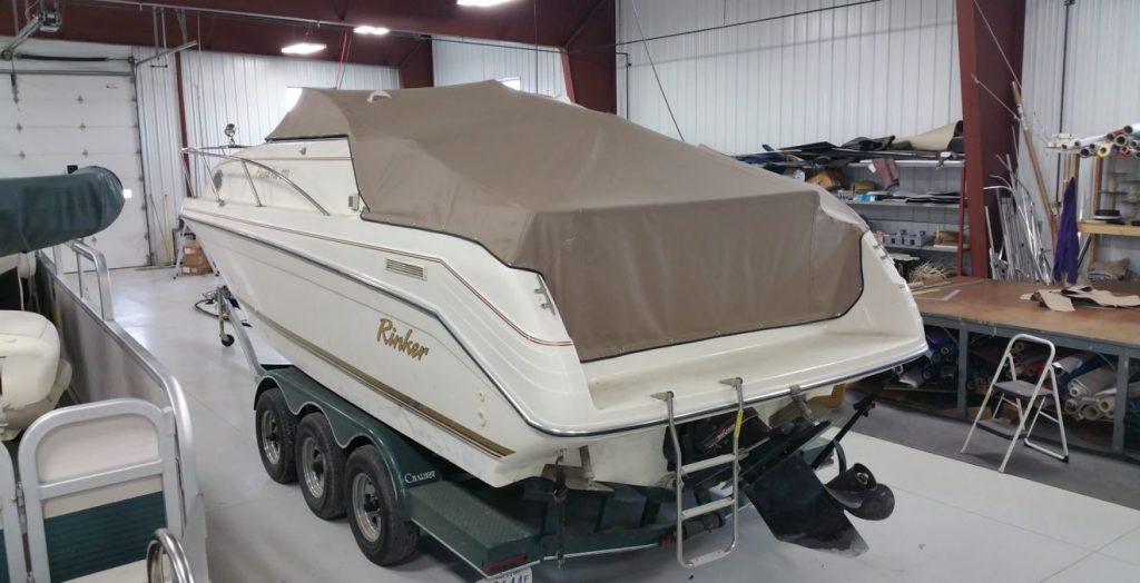 Rinker boat with tan cover.