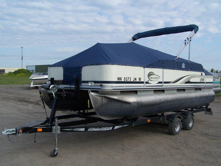 Lowe pontoon with blue cover.