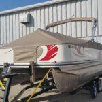 Pontoon with a tan boat cover