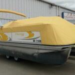 Suncruiser with yellow boat cover in front of T.R.S. Industries