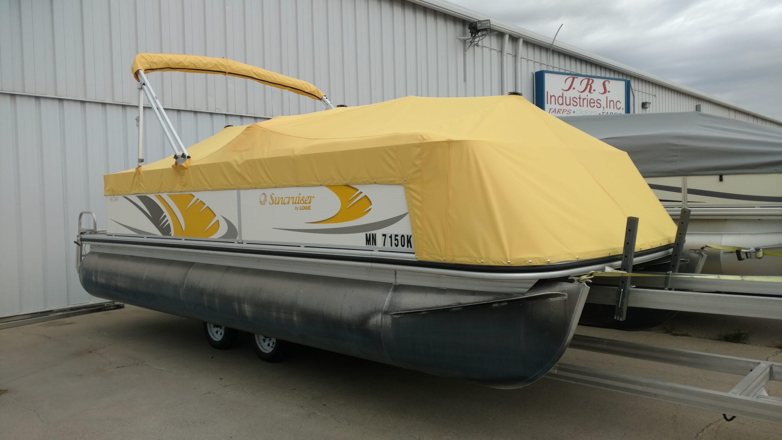 Suncruiser pontoon with yellow cover in front of T.R.S. Industries.