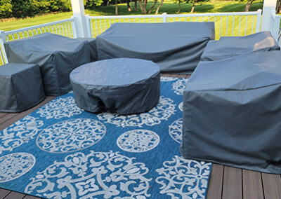 Custom outdoor covers protecting patio furniture and fireplace features