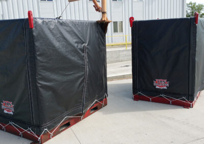 A industrial-strength black protective cover wrapped securely around large-scale agricultural machinery.