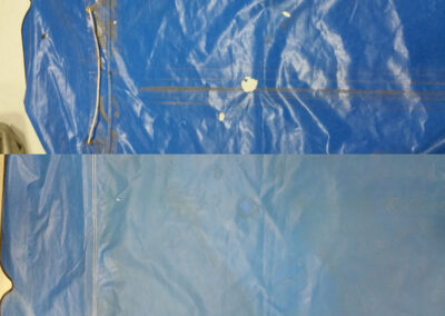 Split view comparing a damaged or patched blue tarp section against a restored tarp surface.