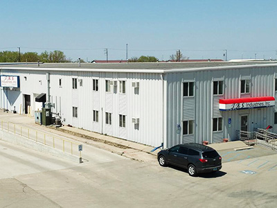 An exterior view of the large TRS Industries facility and office building located in Fargo, ND.