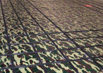 Steel tarp made with camouflage-patterned vinyl and custom webbing