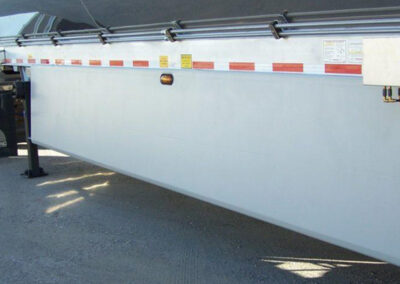 Trailer aerodynamic wind tamer panel mounted along the lower edge