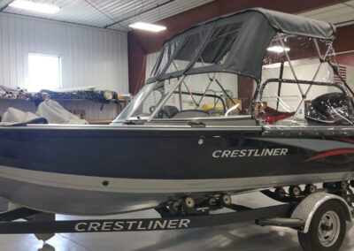 Front perspective of a custom charcoal gray canvas boat bimini top showing the supportive framework.