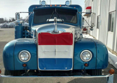 Custom red, white, and blue vinyl winter front installed on a commercial truck