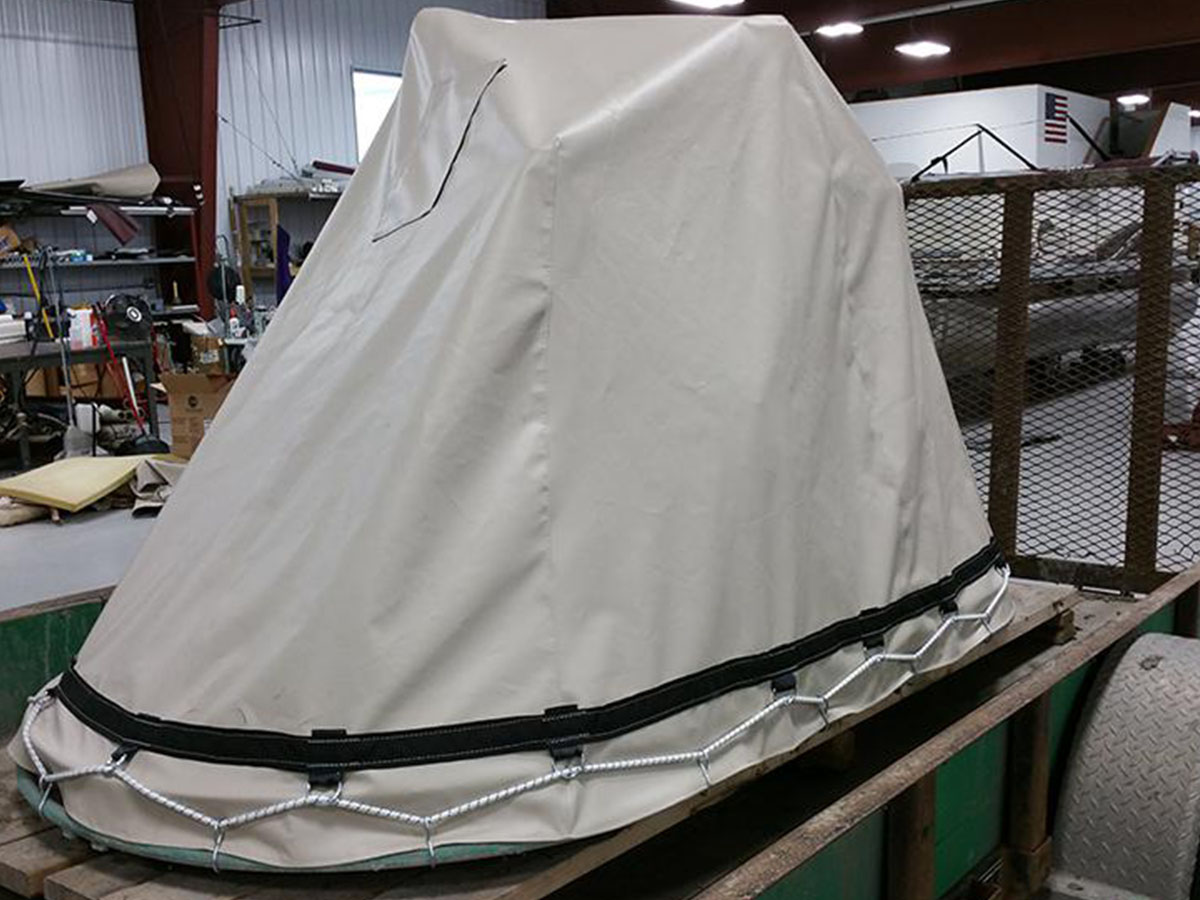 burgundy-bimini-top-with-clear-windshield Side view of a burgundy marine canvas bimini top integrated with a clear vinyl front windshield panel.