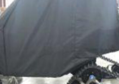 Protective fitted cover installed on a side-by-side off-road vehicle