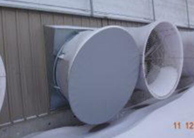 Grain bin fan protected with a custom cover system