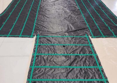 Lumber tarp with rows of D-rings for securing tarp straps
