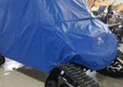 Custom fitted cover protecting a side-by-side off-road vehicle