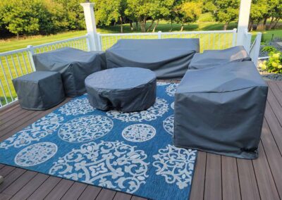 Custom outdoor covers protecting patio furniture and fireplace features