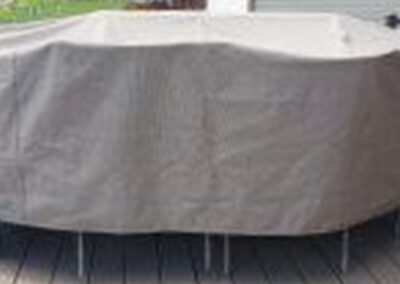 Outdoor patio furniture cover protecting a table and chair set