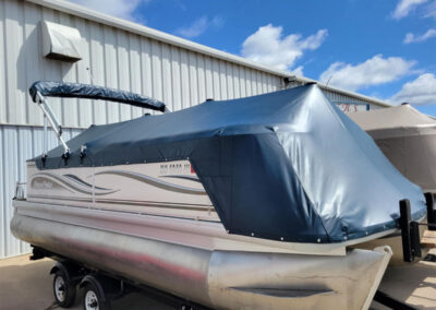 Pontoon boat cover installed with a standard Bimini top