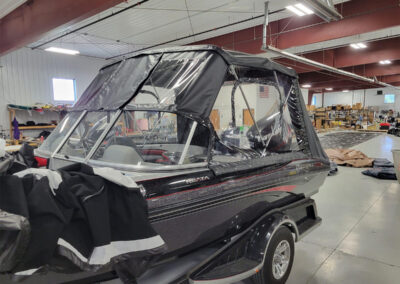 Detailed shot of the support poles and clean stitching of a gray marine canvas bimini top.