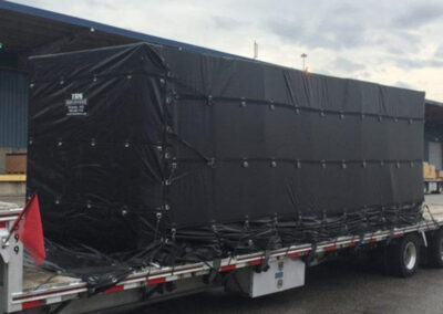 Standard lumber tarp system protecting flatbed cargo loads