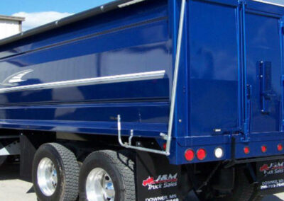 Supreme roll tarp mounted along the top of a hauling trailer