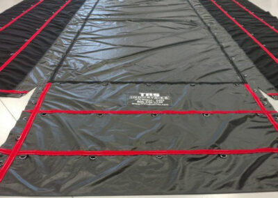 Lumber tarp covering cargo on a hauling trailer
