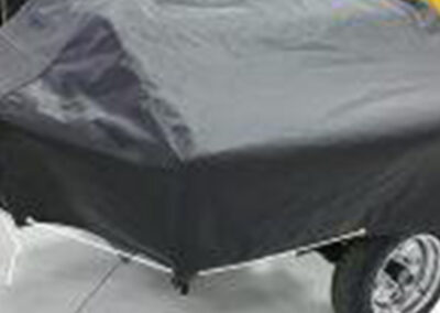 Fitted smoker grill cover mounted on a wheeled trailer